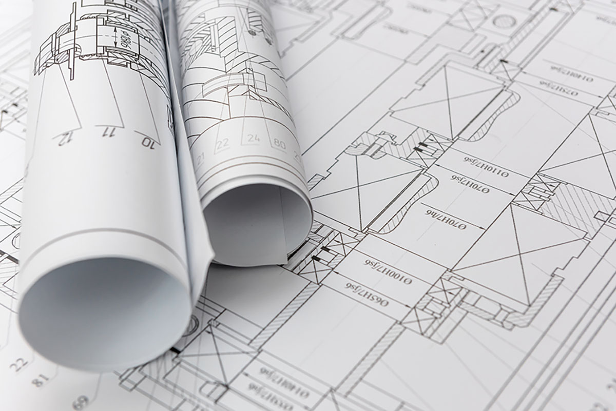 Technical drawings with blueprints in rolls close up. Engineering concept